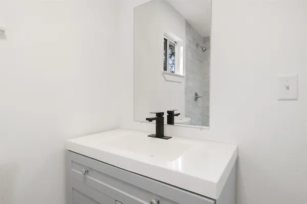 a bathroom with a sink and a mirror