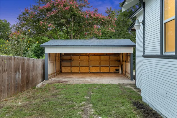a view of a small yard with wooden fence