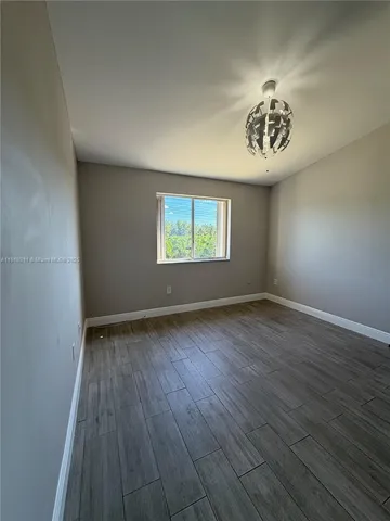 an empty room with a hardwood