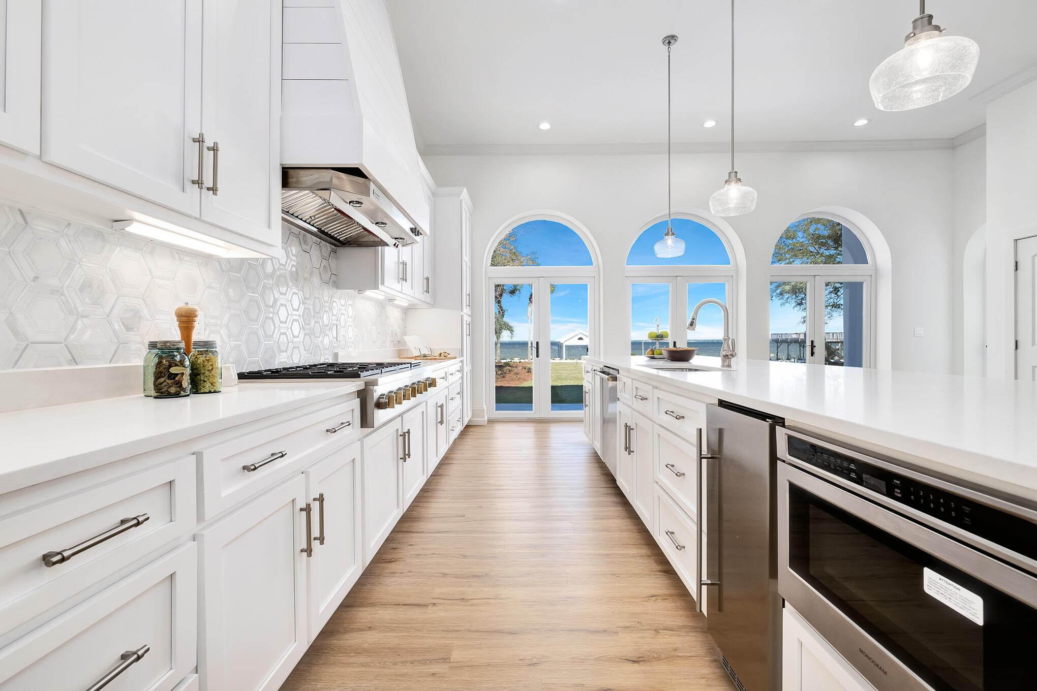 4105 Indian Trail Destin, FL 32541 - Photo 15 of 70 a large kitchen with lots of counter space wooden floor and stainless steel appliances