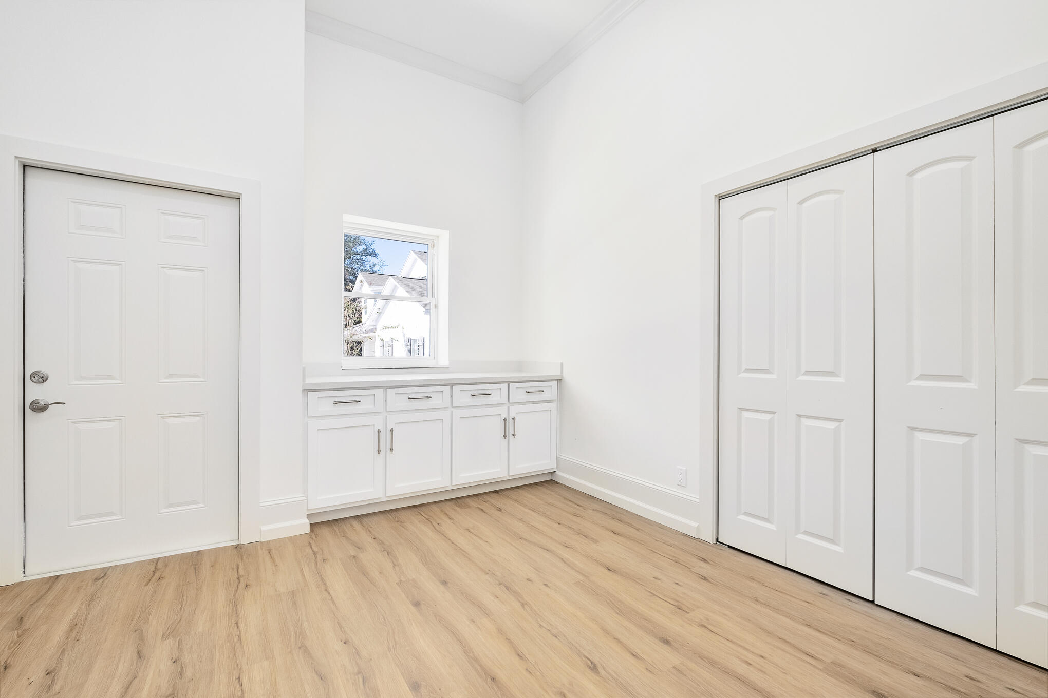 4105 Indian Trail Destin, FL 32541 - Photo 22 of 70 an empty room with wooden floor cabinet and windows