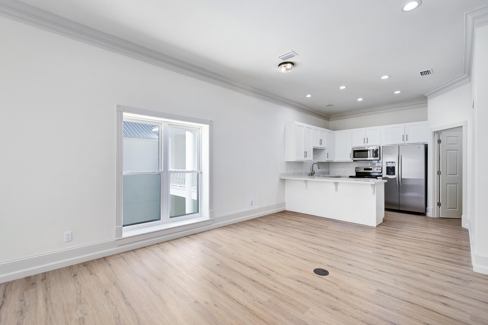 4105 Indian Trail Destin, FL 32541 - Photo 62 of 70 a view of kitchen with granite countertop refrigerator oven sink and white cabinets with wooden floor