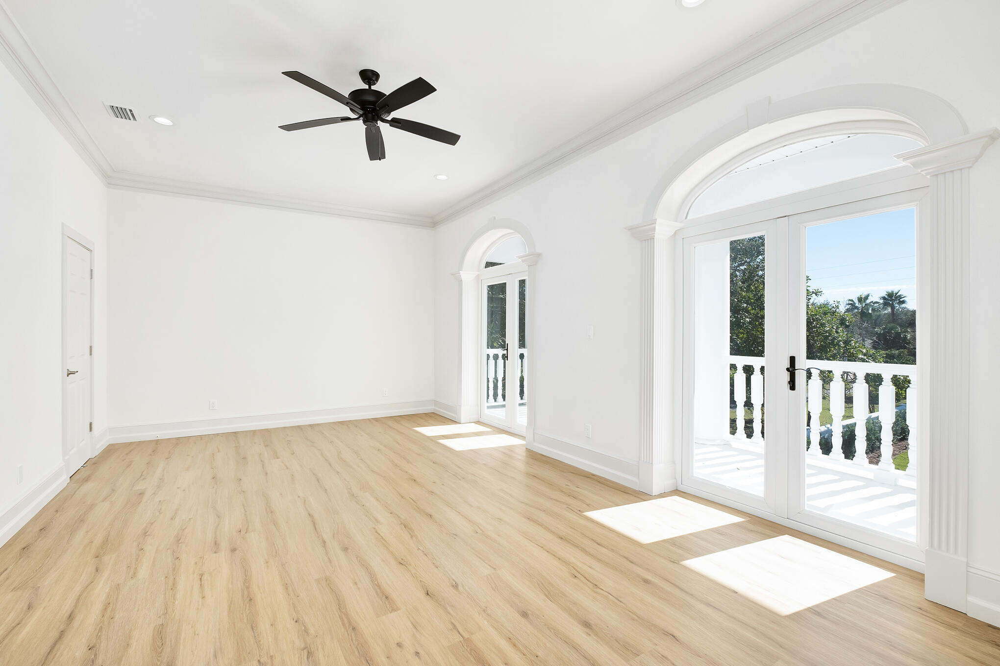 4105 Indian Trail Destin, FL 32541 - Photo 69 of 70 an empty room with wooden floor a ceiling fan and windows
