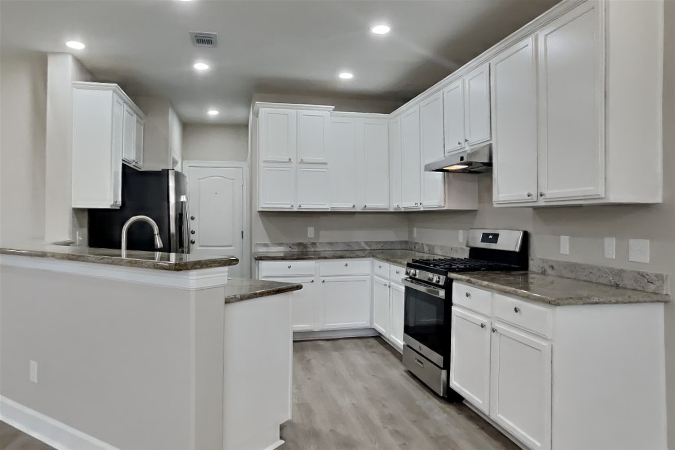 4718 Wild Bluebonnet Way Houston, TX 77084 - Photo 4 of 20 a kitchen with stainless steel appliances granite countertop a sink a stove and cabinets