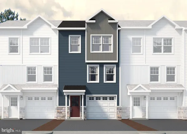 a front view of a residential apartment building with a yard