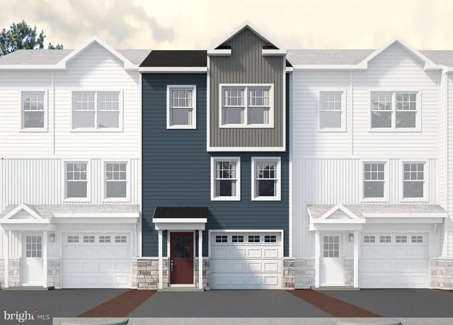 a front view of a residential apartment building with a yard