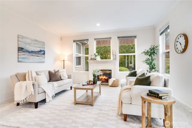 a view of a livingroom with furniture a dinning room and windows