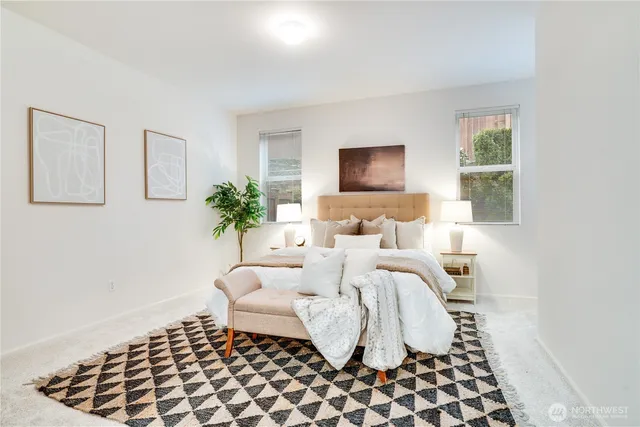 a bedroom with bed and a potted plant