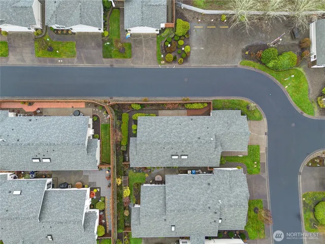 an aerial view of a house with swimming pool and outdoor seating