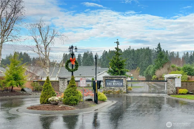 a view of a house with a big yard and palm trees