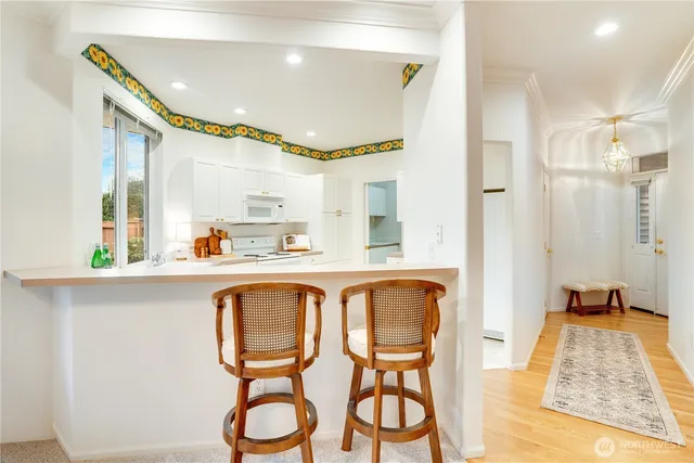 a kitchen with white cabinets and white appliances