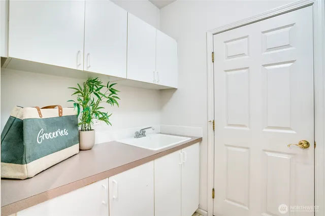 a kitchen with a sink and cabinets