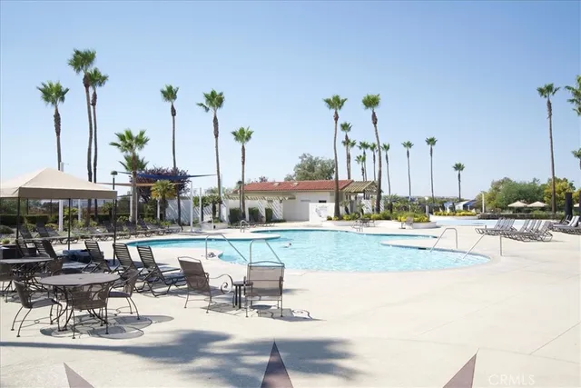 a view of a swimming pool with outdoor seating