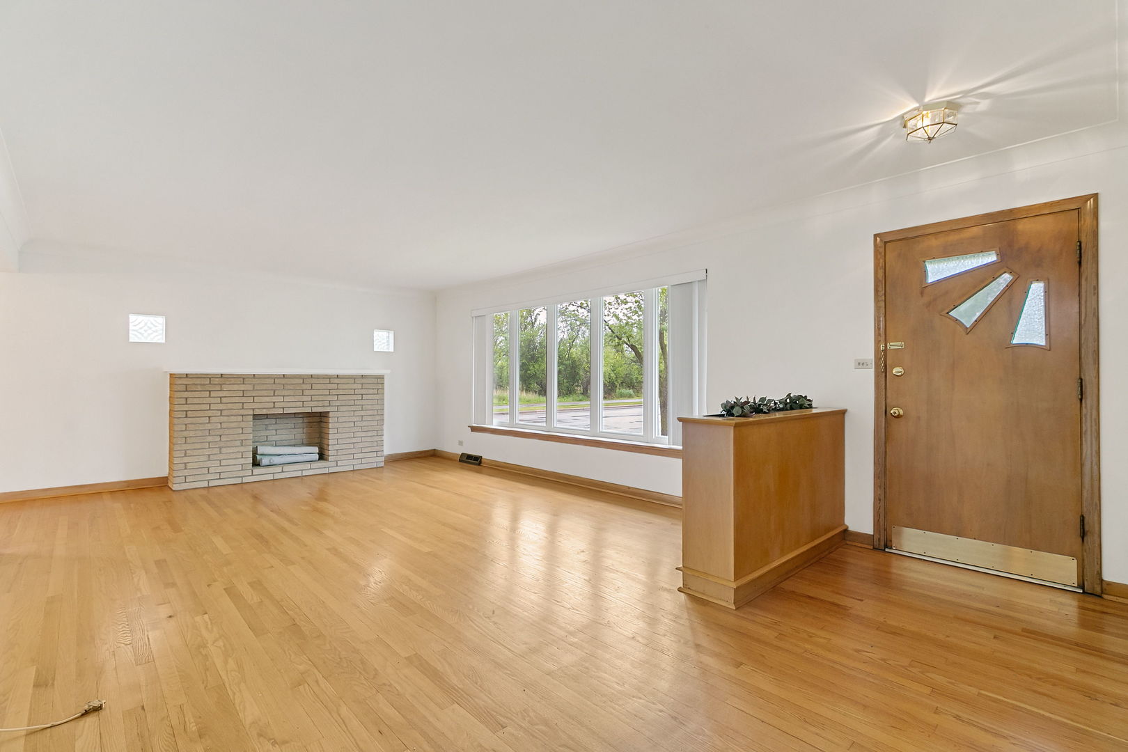 2549 2nd Avenue North Riverside, IL 60546 - Photo 3 of 18 a view of an empty room with wooden floor and a window