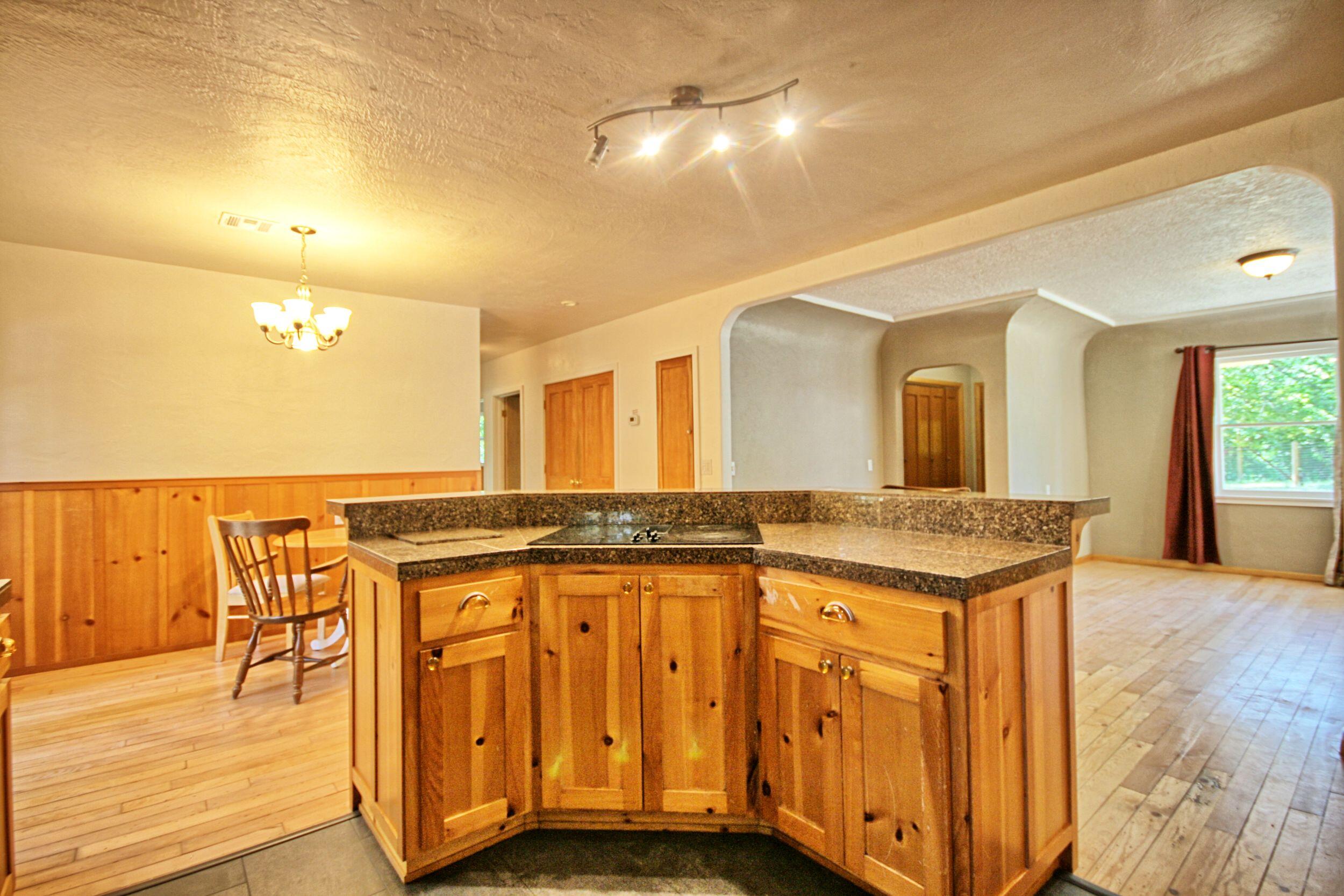 199 Powell Creek Road Williams, OR 97544 - Photo 22 of 57 a bathroom with a granite countertop sink and a large mirror