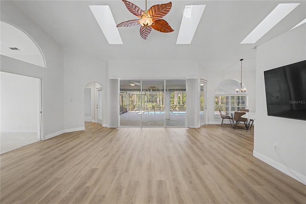 15031 Surrey Bend Spring Hill, FL 34609 - Photo 12 of 77 a view of empty room with wooden floor and fan