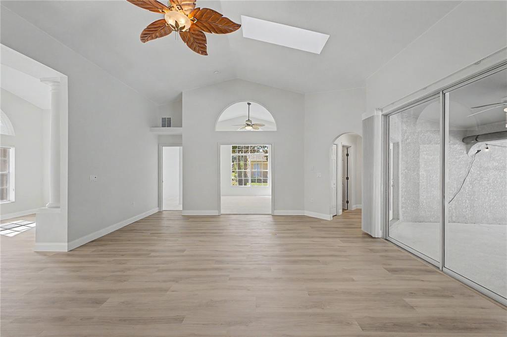 15031 Surrey Bend Spring Hill, FL 34609 - Photo 13 of 77 a view of an empty room with a window and wooden floor