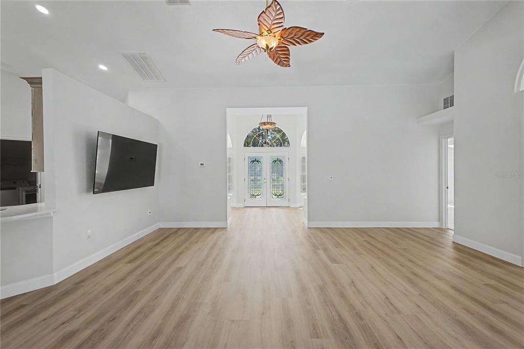15031 Surrey Bend Spring Hill, FL 34609 - Photo 14 of 77 wooden floor in an empty room with a window