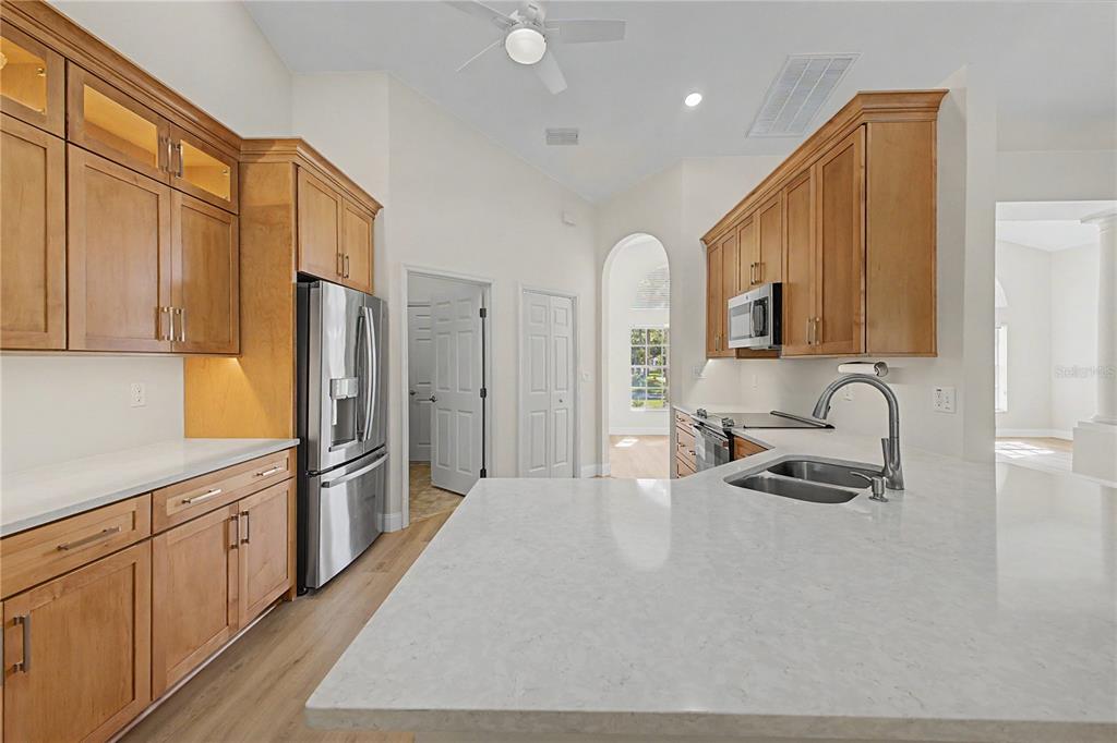 15031 Surrey Bend Spring Hill, FL 34609 - Photo 18 of 77 a kitchen with stainless steel appliances granite countertop a refrigerator sink and cabinets