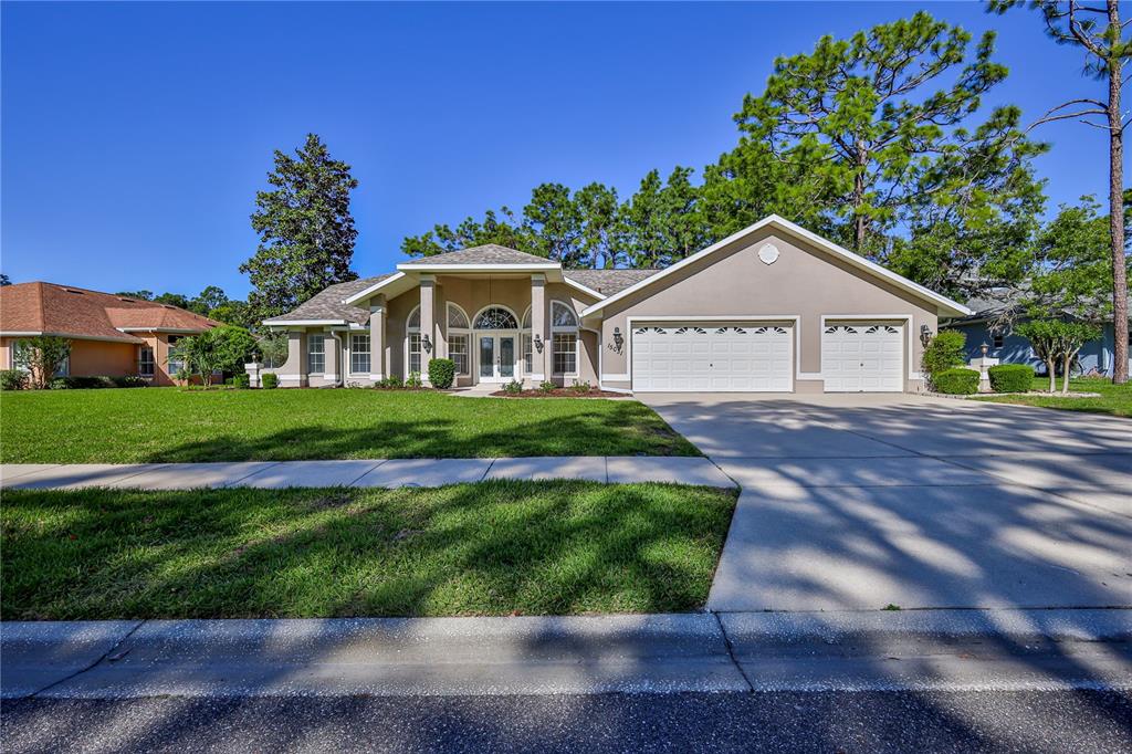 15031 Surrey Bend Spring Hill, FL 34609 - Photo 2 of 77 a front view of a house with a yard