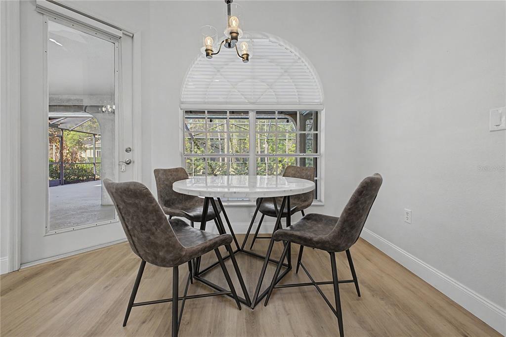 15031 Surrey Bend Spring Hill, FL 34609 - Photo 26 of 77 a dining room with furniture and window