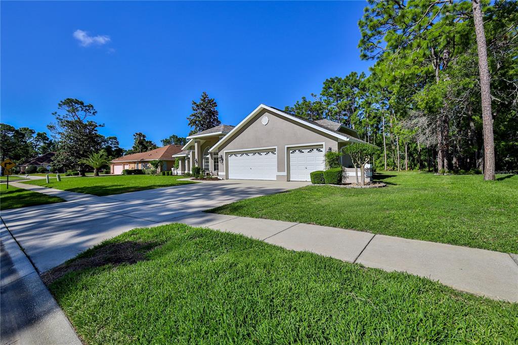 15031 Surrey Bend Spring Hill, FL 34609 - Photo 3 of 77 a front view of a house with a yard