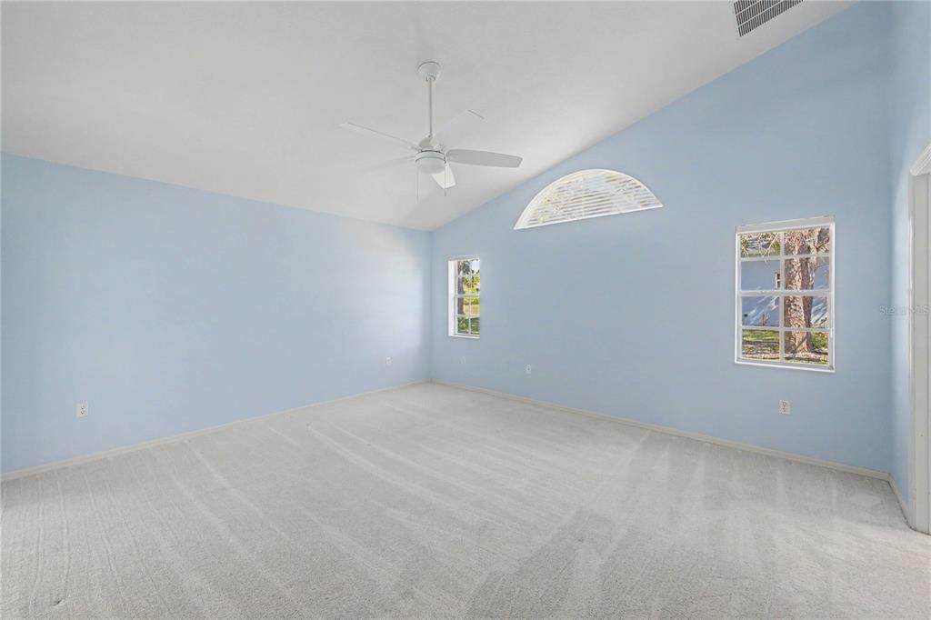 15031 Surrey Bend Spring Hill, FL 34609 - Photo 35 of 77 an empty room with windows and ceiling fan