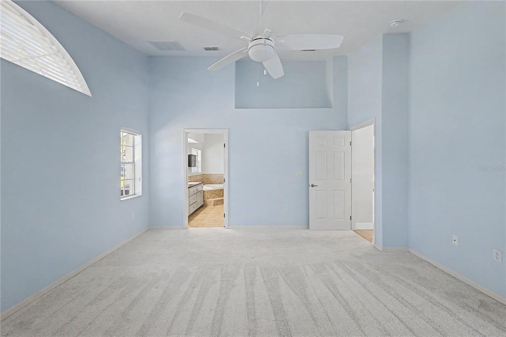 15031 Surrey Bend Spring Hill, FL 34609 - Photo 38 of 77 a view of a kitchen with wooden cabinet and a hallway