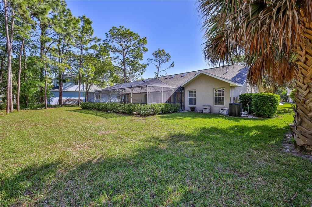 15031 Surrey Bend Spring Hill, FL 34609 - Photo 52 of 77 a front view of house with yard and green space