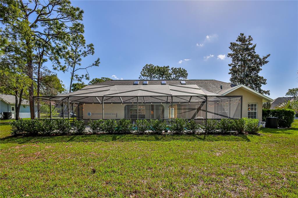 15031 Surrey Bend Spring Hill, FL 34609 - Photo 53 of 77 a front view of a house with a garden