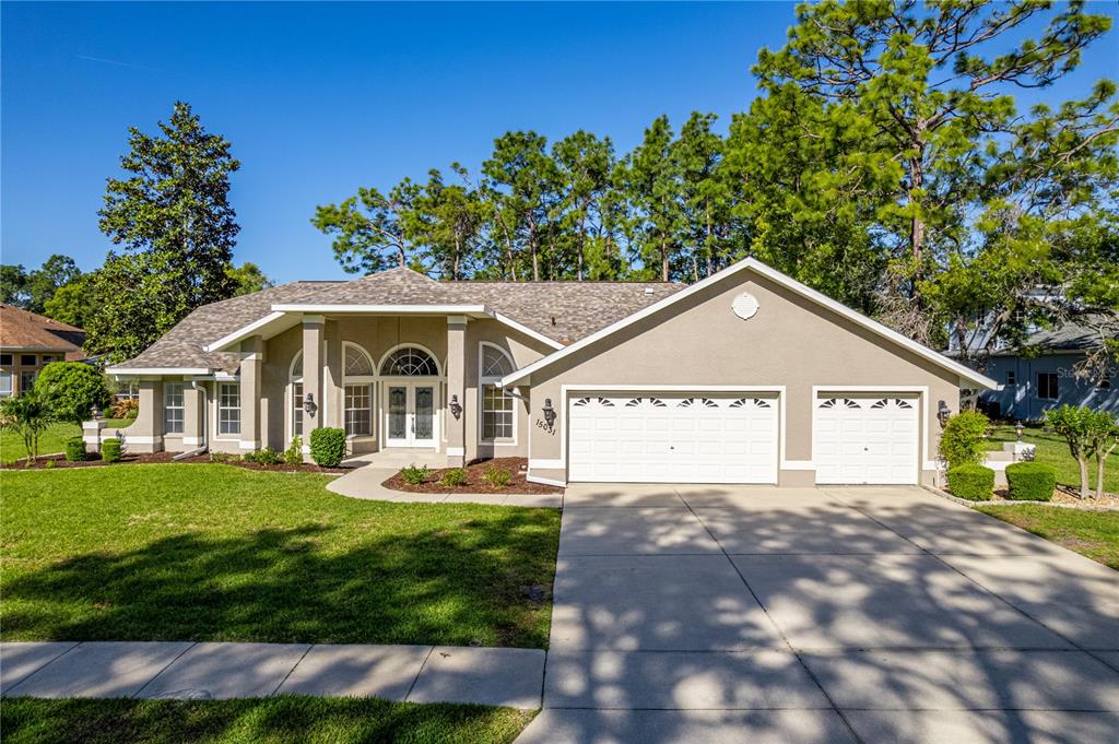 15031 Surrey Bend Spring Hill, FL 34609 - Photo 57 of 77 a view of a house with a yard