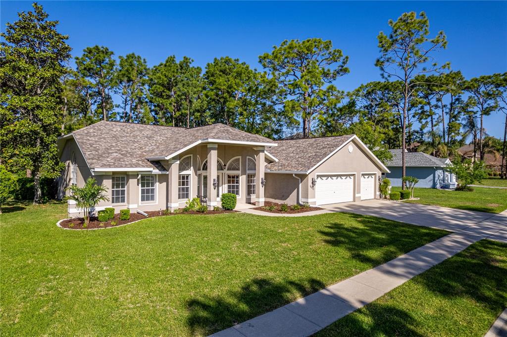 15031 Surrey Bend Spring Hill, FL 34609 - Photo 58 of 77 a front view of a house with a yard