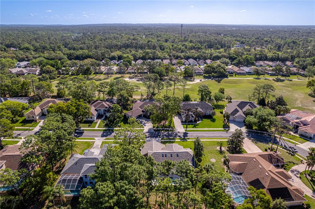 15031 Surrey Bend Spring Hill, FL 34609 - Photo 66 of 77 an aerial view of residential houses with outdoor space and lake view