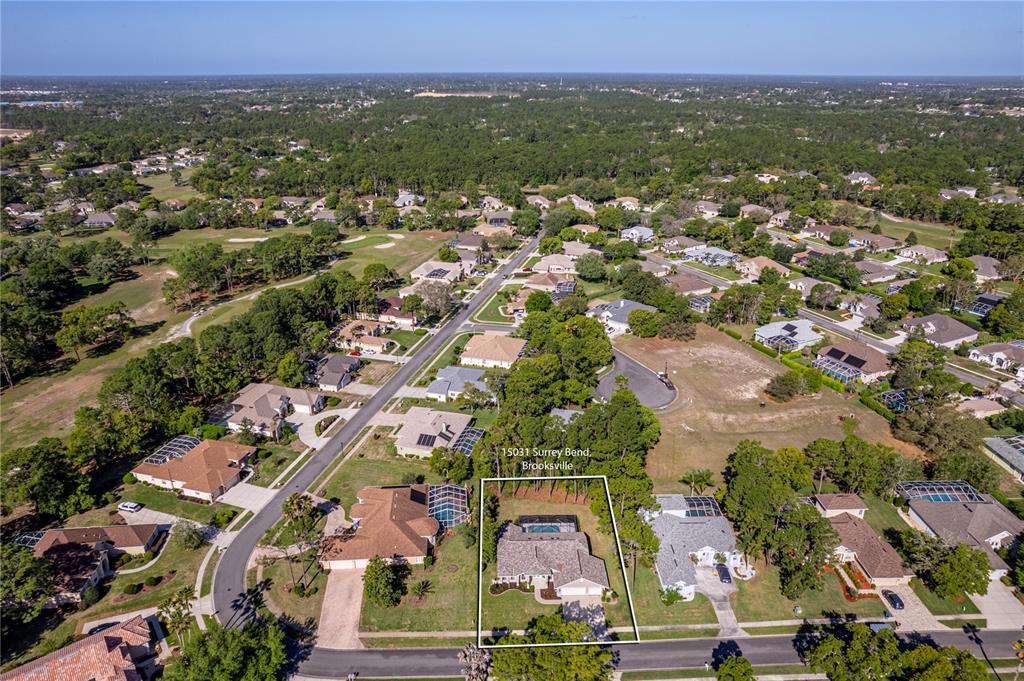 15031 Surrey Bend Spring Hill, FL 34609 - Photo 72 of 77 an aerial view of residential houses with outdoor space and trees
