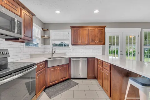 a kitchen with stainless steel appliances granite countertop a sink and cabinets