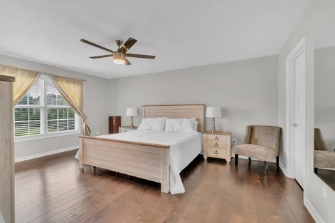 a bedroom with a bed and a large window