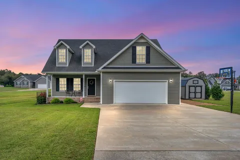 a front view of a house with a yard and garage