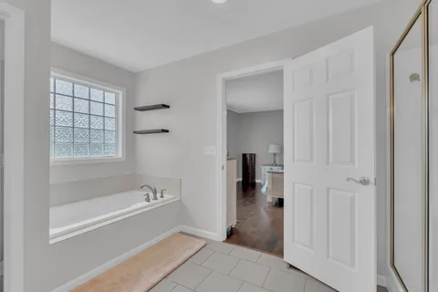 a spacious bathroom with a bathtub and a shower