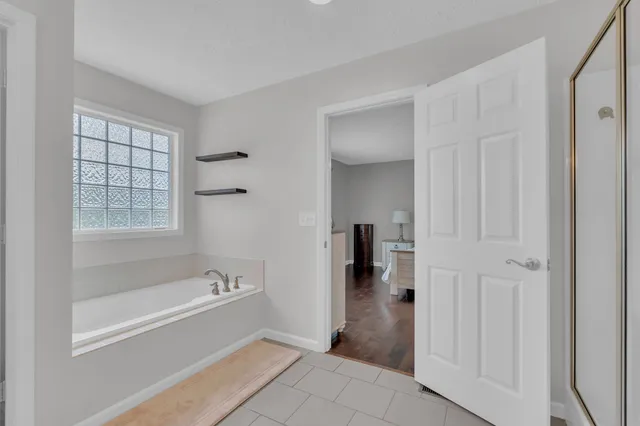 a spacious bathroom with a bathtub and a shower