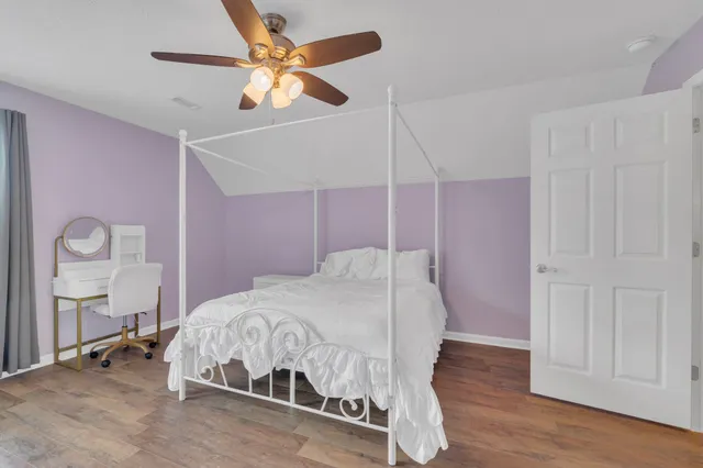 a bedroom with a bed and a table