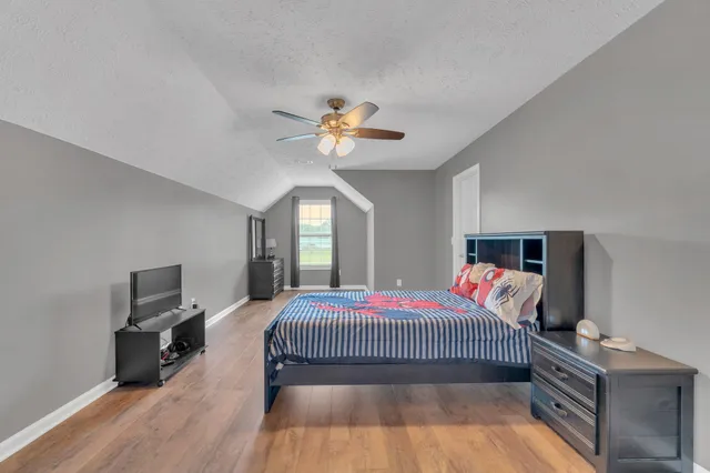 a bedroom with a bed and a chandelier
