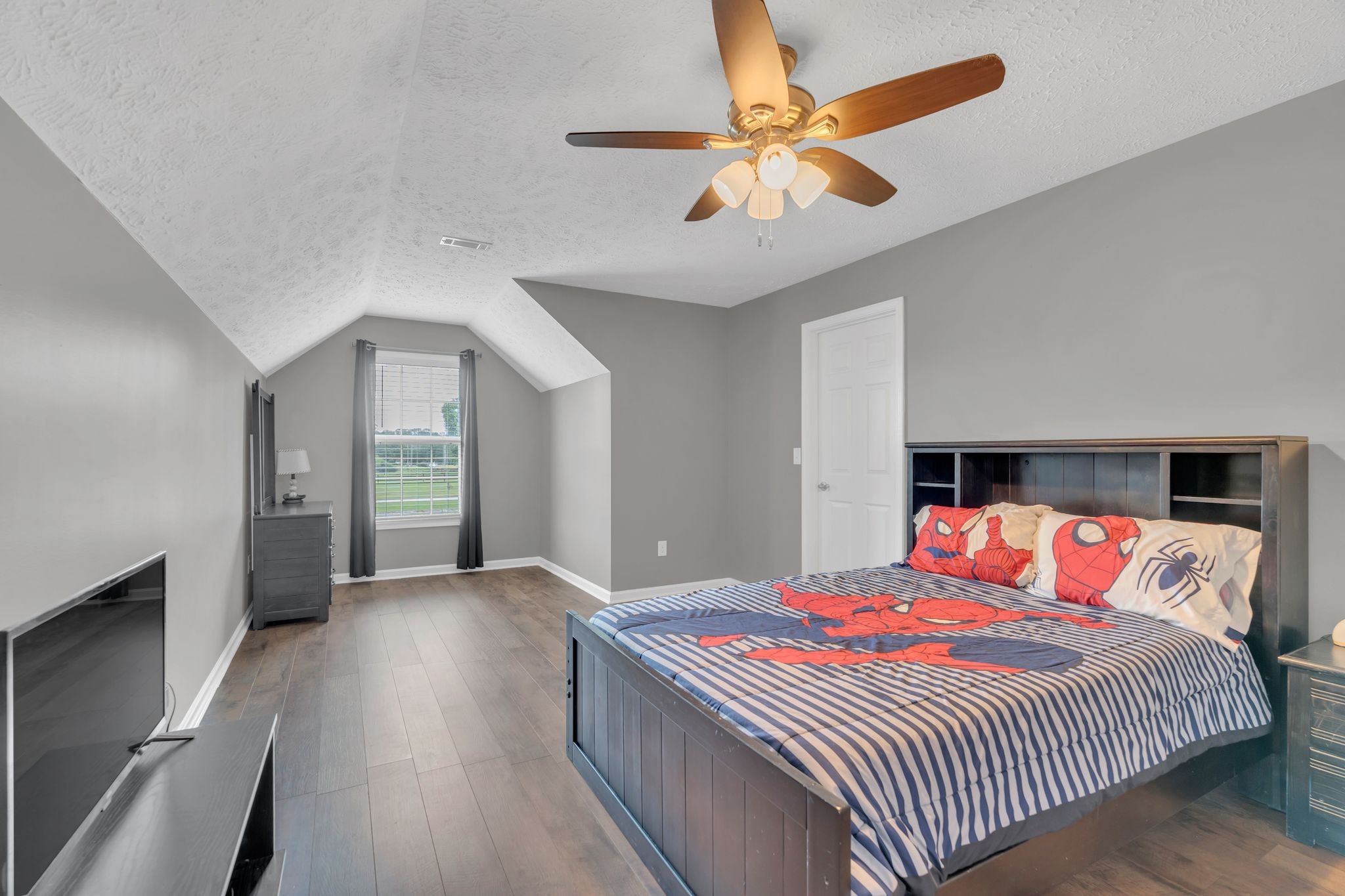 124 Houston Bell Road Manchester, TN 37355 - Photo 30 of 43 a bedroom with a large bed and a chandelier