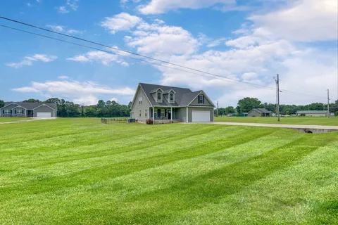 a front view of house with yard and green space