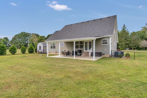 a view of a house with a backyard