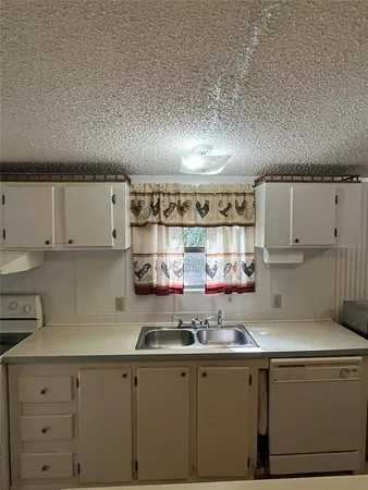 a kitchen with a sink and cabinets