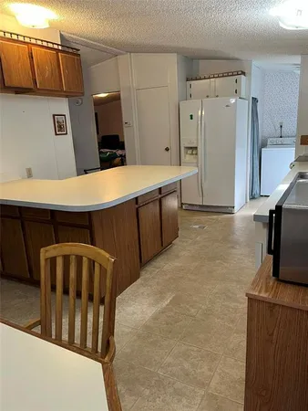 a kitchen with stainless steel appliances a refrigerator and a stove