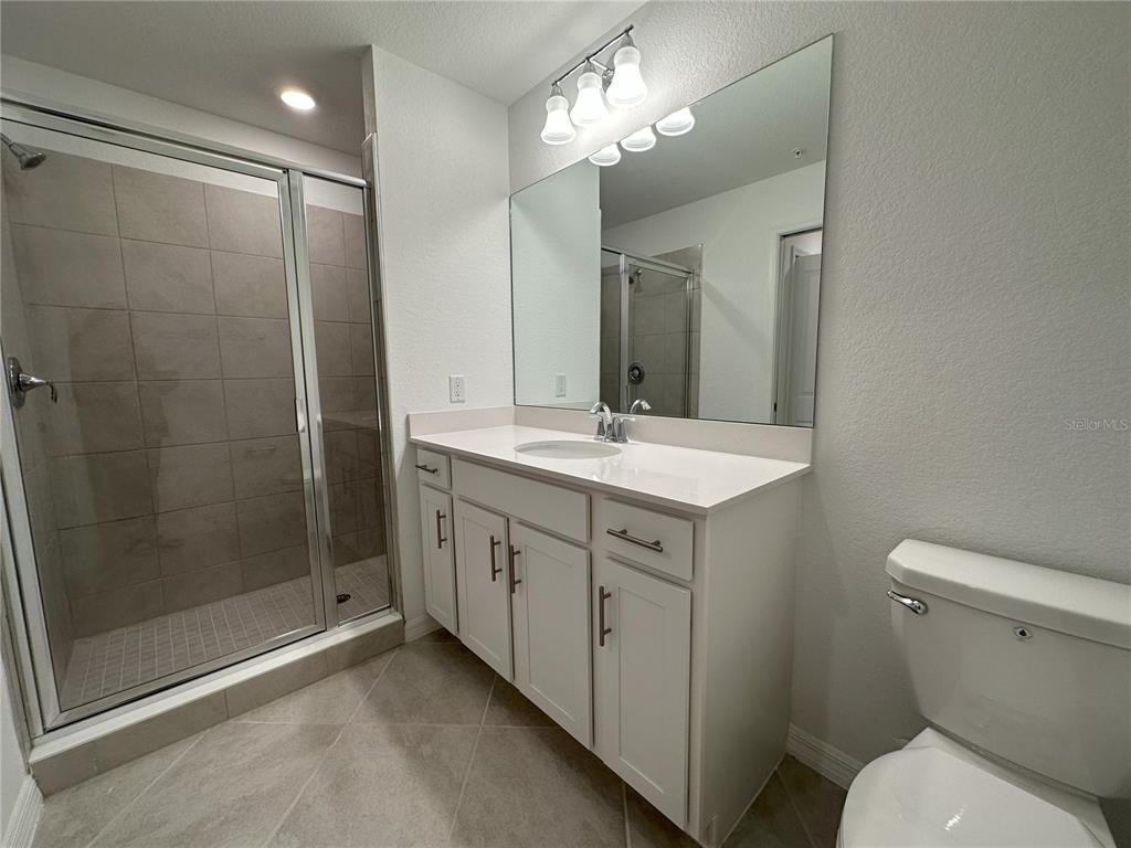 14131 Heritage Landing Boulevard, Unit 822 Punta Gorda, FL 33955 - Photo 13 of 51 a bathroom with a shower sink and mirror