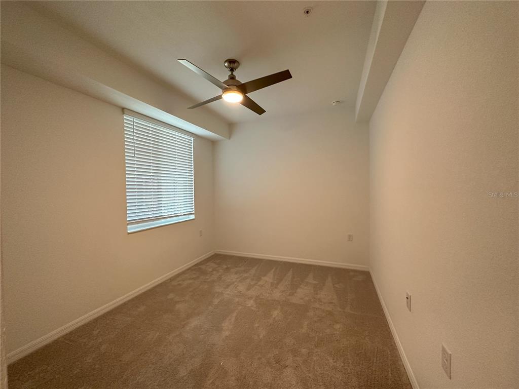 14131 Heritage Landing Boulevard, Unit 822 Punta Gorda, FL 33955 - Photo 16 of 51 an empty room with a window and a ceiling fan