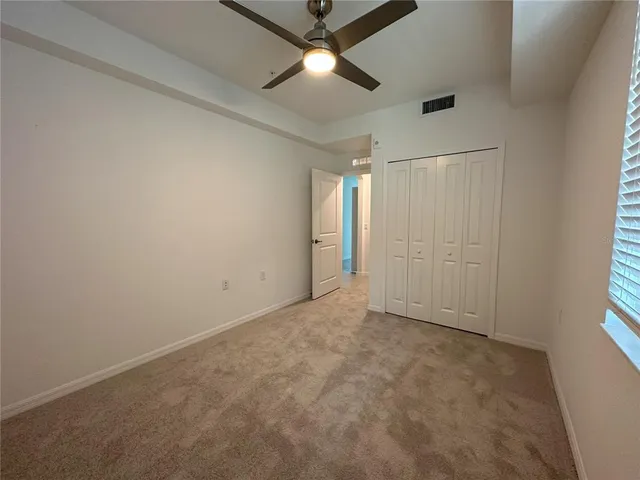 a bathroom with a granite countertop sink a toilet and a mirror