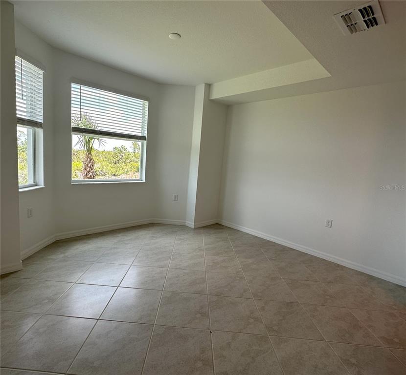 14131 Heritage Landing Boulevard, Unit 822 Punta Gorda, FL 33955 - Photo 5 of 51 an empty room with windows